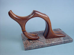 "Manaya" sculptural stand hints at kneeled figure, hand carved in American Black Walnut, Red Oak, migmatite granite base